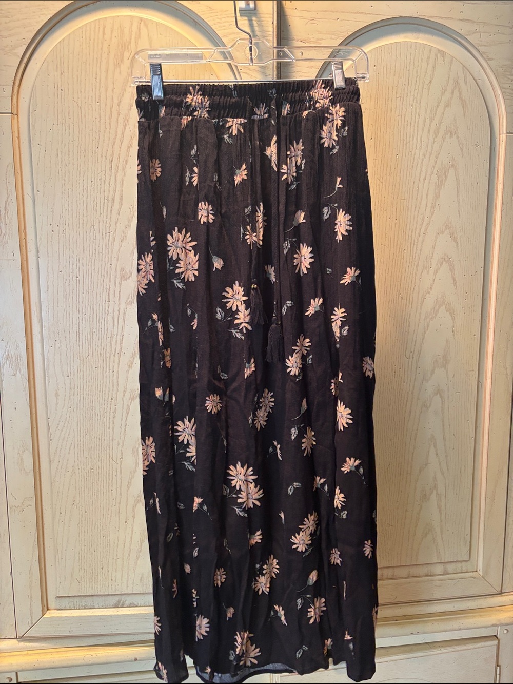 Black Floral Maxi Skirt with Pink Daisy Print. Has two slits in the front.